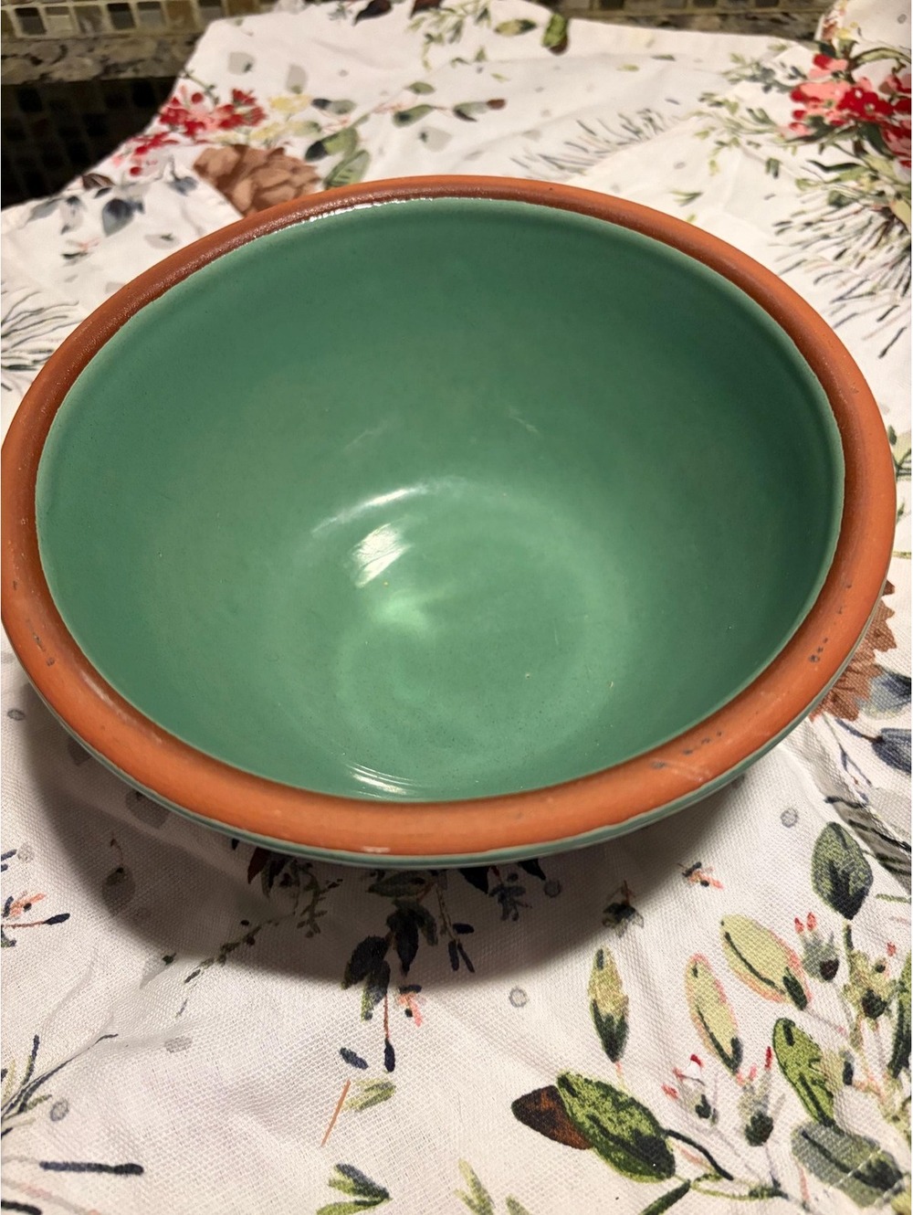 A vintage two-tone glazed ceramic mixing bowl with terracotta rim.